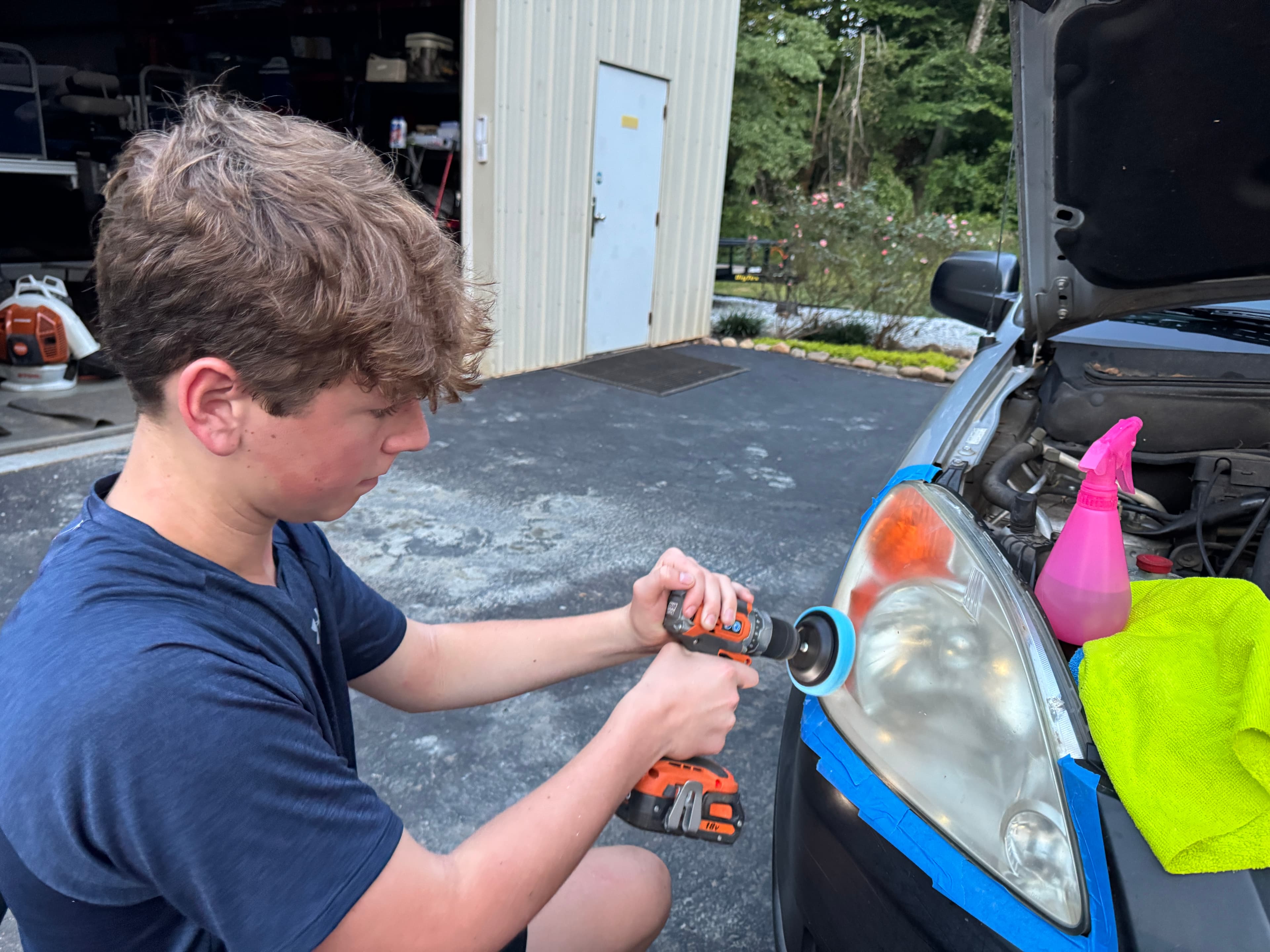 Landon detailing a vehicle headlight